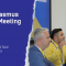 The visual shows on the left the title: "GaragErasmus Annual Meeting 2026" and subtitle: Napoli, Università Suor Orsola Benincasa. On the right side there is a picture of four speakers 